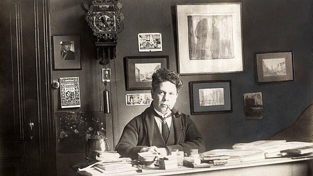 Ein Flame durch und durch, deutschfreundlich sein Kulturverst&auml;ndnis: Der Pfeifenraucher Felix Timmermans an seinem Schreibtisch, an der Wand ein Deutscher Kalender (1926).