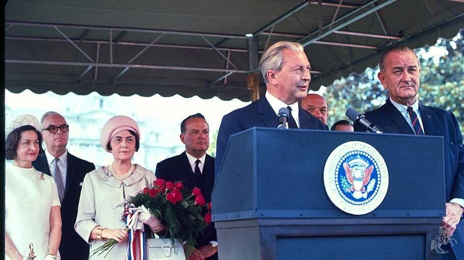 President  Lyndon  Baines  Johnson  and  Chancellor  Kurt  Georg  Kiesinger  standing  at  podium,