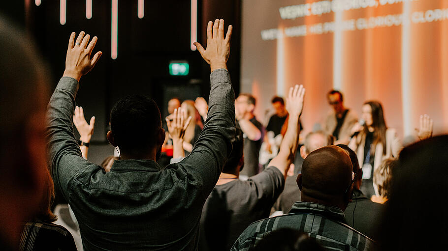 Hands in the air of people who praise God at church service