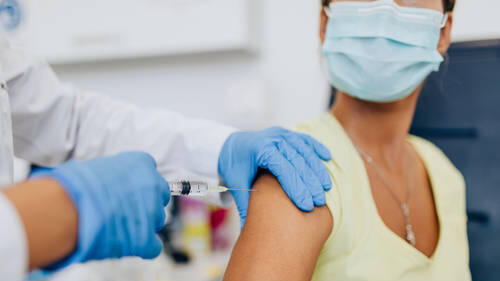 March 29, 2023: Female doctor or nurse giving shot or vaccine to a patient s shoulder. Vaccination and prevention agains