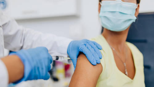 March 29, 2023: Female doctor or nurse giving shot or vaccine to a patient s shoulder. Vaccination and prevention agains