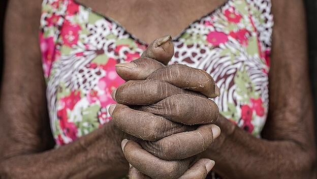 Senior Afro-Brazilian woman with joined hands Brazil, State of Minas Gerais ,editorial use only PUBLICATIONxINxGERxSUIxA