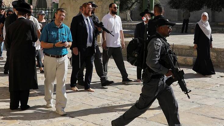 Israeli policemen escort Yehuda Glick, a member of Knesset, the Israeli parliament, as he visits the compound known to Muslims as Noble Sanctuary and to Jews as Temple Mount, in Jerusalem's Old City
