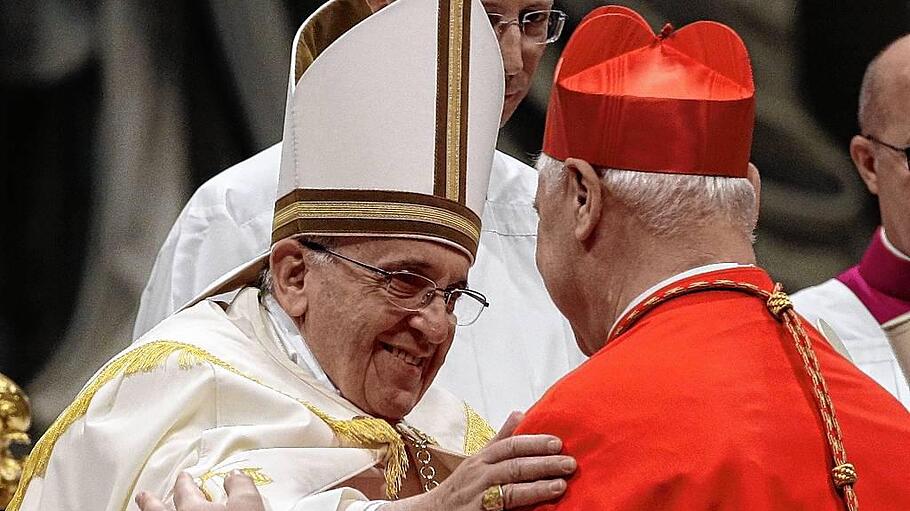 Pope Francis embraces newly elected cardinal Muller of Germany during a consistory ceremony in Saint Peter's Basilica at the Vatican