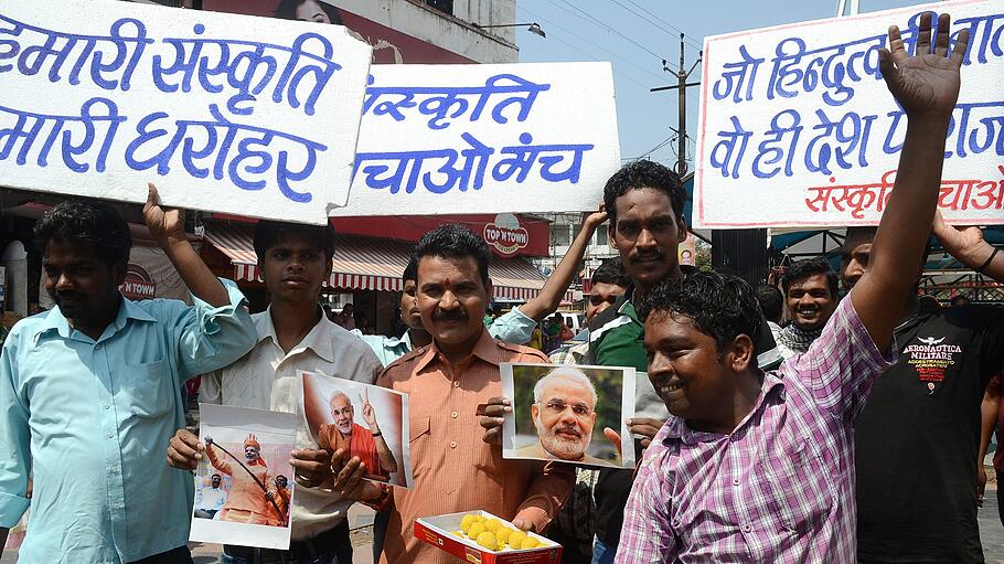 Bharatiya Janata Party (BJP) supporters celebrate with sweets in