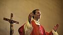 Catholic priest on altar praying with open arms during mass service in church model released Symbolfoto PUBLICATIONxINx
