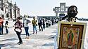 MEXICO CITY, MEXICO - DECEMBER 8: A Faithful holds a picture of the Virgin of Guadalupe while visit the Basilica of Guad