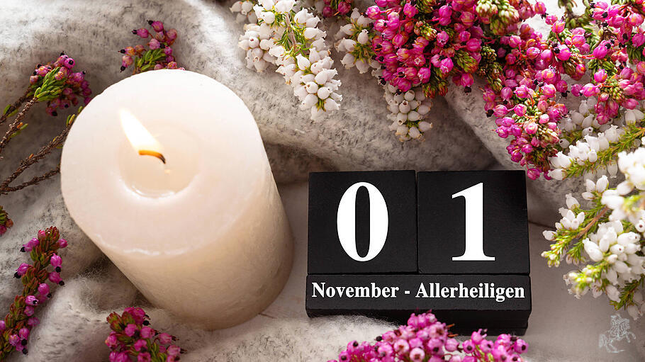 Bavaria, Germany - October 17, 2025: PHOTOMONTAGE, calendar cube with a candle and flowers, greeting for All Saints Day