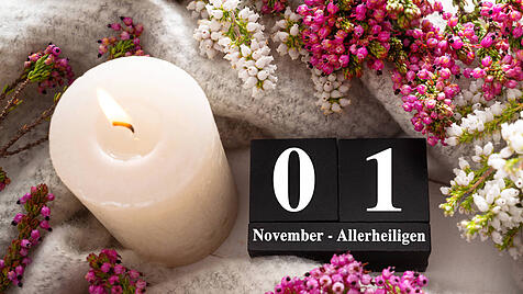 Bavaria, Germany - October 17, 2025: PHOTOMONTAGE, calendar cube with a candle and flowers, greeting for All Saints Day