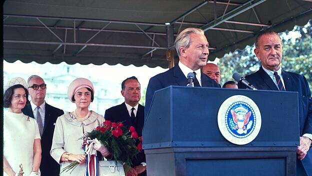 President  Lyndon  Baines  Johnson  and  Chancellor  Kurt  Georg  Kiesinger  standing  at  podium,