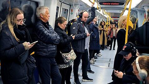 Copenhagen/Denmark/08 November 2022/ people use iphnes and smartphone during journey in metro in Copenhagen (Photo. Fran