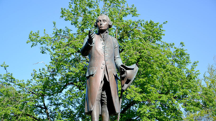Monument to the philosopher Immanuel Kant against the background of foliage. Kaliningrad