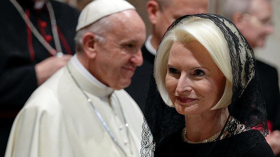U.S. ambassador to the Holy See Callista Gingrich walks past Pope Francis during the traditional exchange of the New Year greetings in the Regal Room at the Vatican