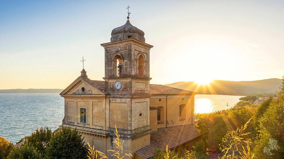 Church Assumption of Virgin Mary near Lake Bracciano at sunset in Italy