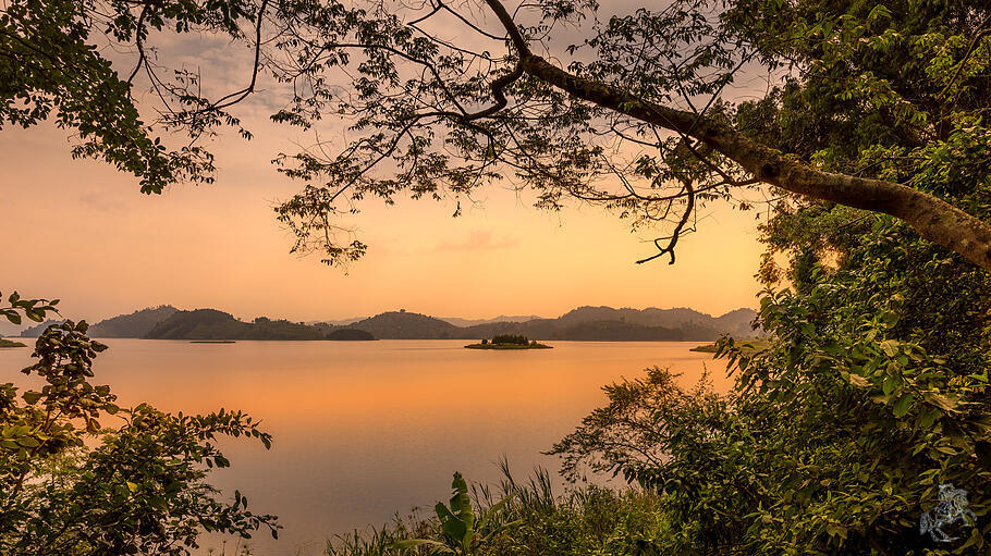 Lake Mutanda at sunset with view on the volcanoes mount Muhavuru and mount Gahinga in East Africa, a
