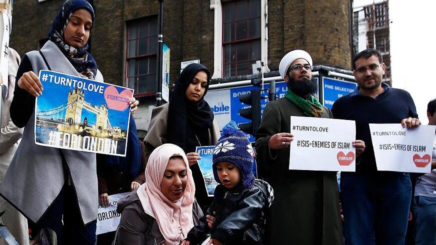 Muslims pray at a floral tribute near London Bridge in London