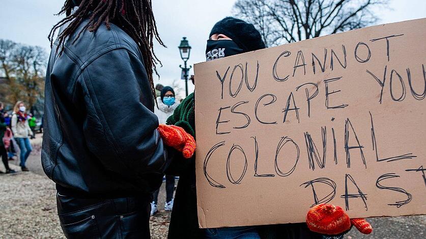 December 6, 2020, The Hague, Netherlands: A protester holds a placard against colonialism during the demonstration..Sev