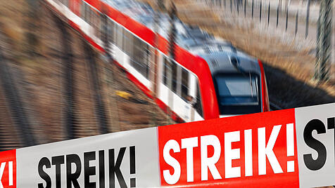 10 March 2024: Barrier tape with the inscription: Strike! in front of a train on a railroad track. Themed picture rail s