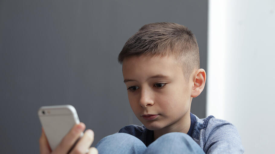 Upset boy with smartphone