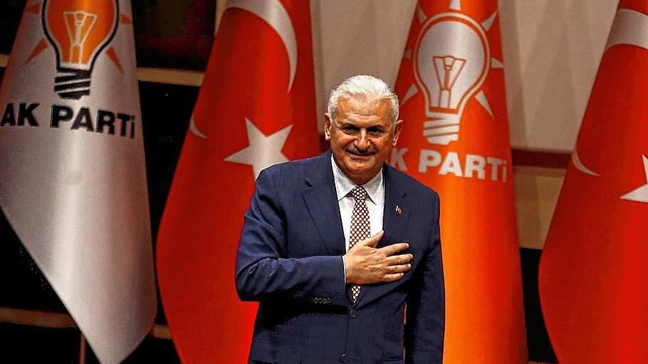 Turkey's likely next prime minister and incoming leader of the ruling AK Party Binali Yildirim greets party members during a meeting in Ankara