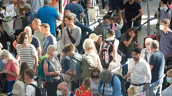 Holiday Traffic Chaos Continue At Düsseldorf Airport Passengers are seen waiting in front of Eurowings check in counter
