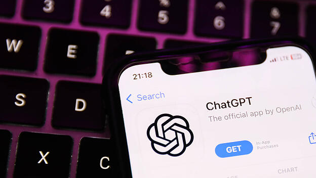 ChatGPT Official App Photo Illustrations A laptop keyboard and ChatGPT on AppStore displayed on a phone screen are seen