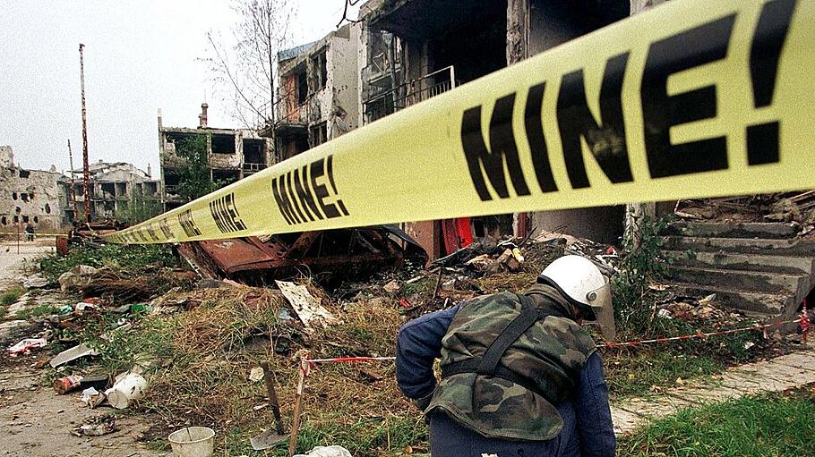 A Bosnian man searches for landmines in Sarajevo's suburb of Nedjarici October 27. Around 50 people ..