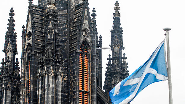 Die schottische Flagge vor einem Kirchturm