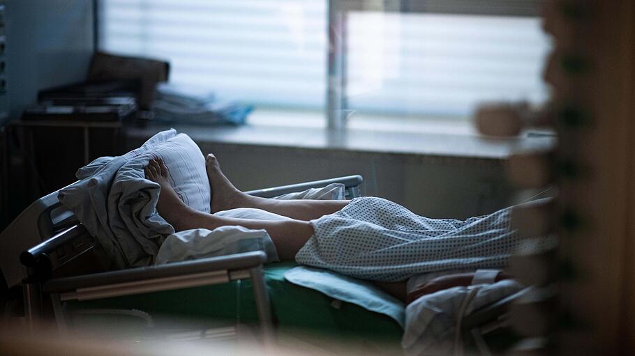 Patient liegt in einem Zimmer auf einer Corona-Intensivstation