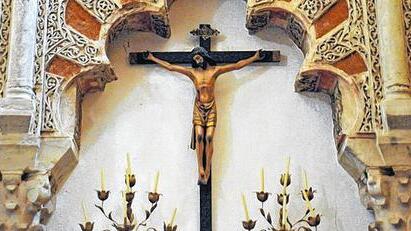 Kreuz in der Kathedrale von Córdoba unter maurischen Bögen.