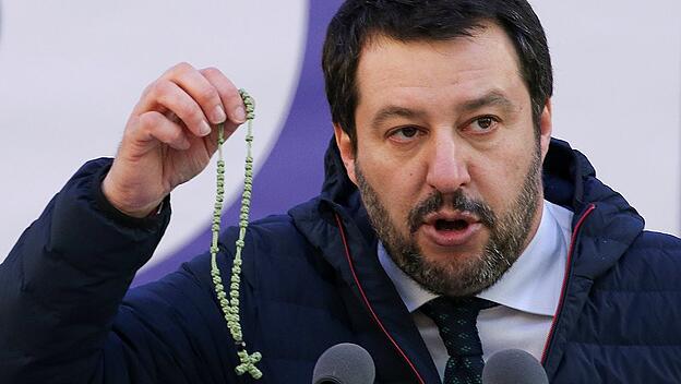 Italian Northern League leader Matteo Salvini shows a rosary as he speaks during a political rally in Milan