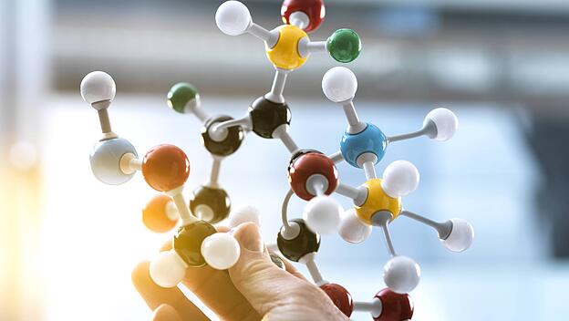 Scientist holding a molecular model model released Symbolfoto property released PUBLICATIONxINxGERxS