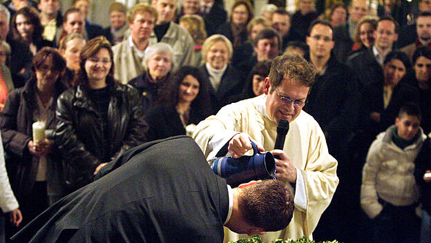 Taufe eines Erwachsenen in der katholischen Basilika St. Aposteln in Köln