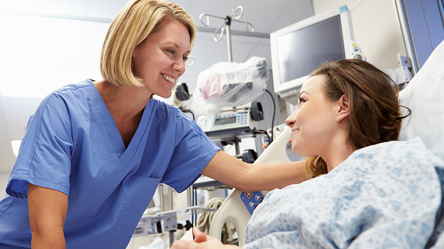 Young Female Patient Talking To Nurse In Emergency Room