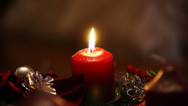 Eine brennende Kerze im Advent.