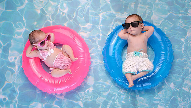 Baby Twin Boy and Girl Floating on Swim Rings
